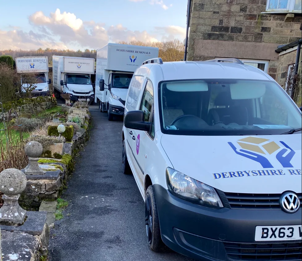 Professional movers from Derbyshire Removals carefully packing items into boxes